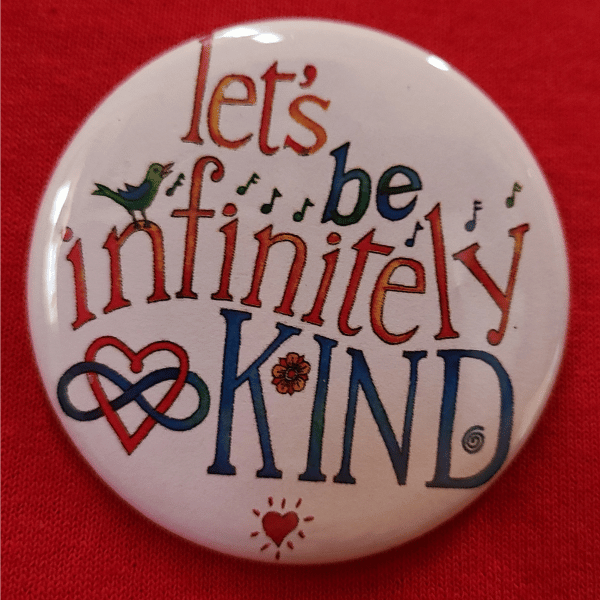 Infinitely Kind button on red shirt