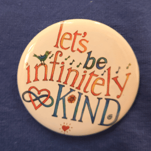 Infinitely Kind button on blue shirt